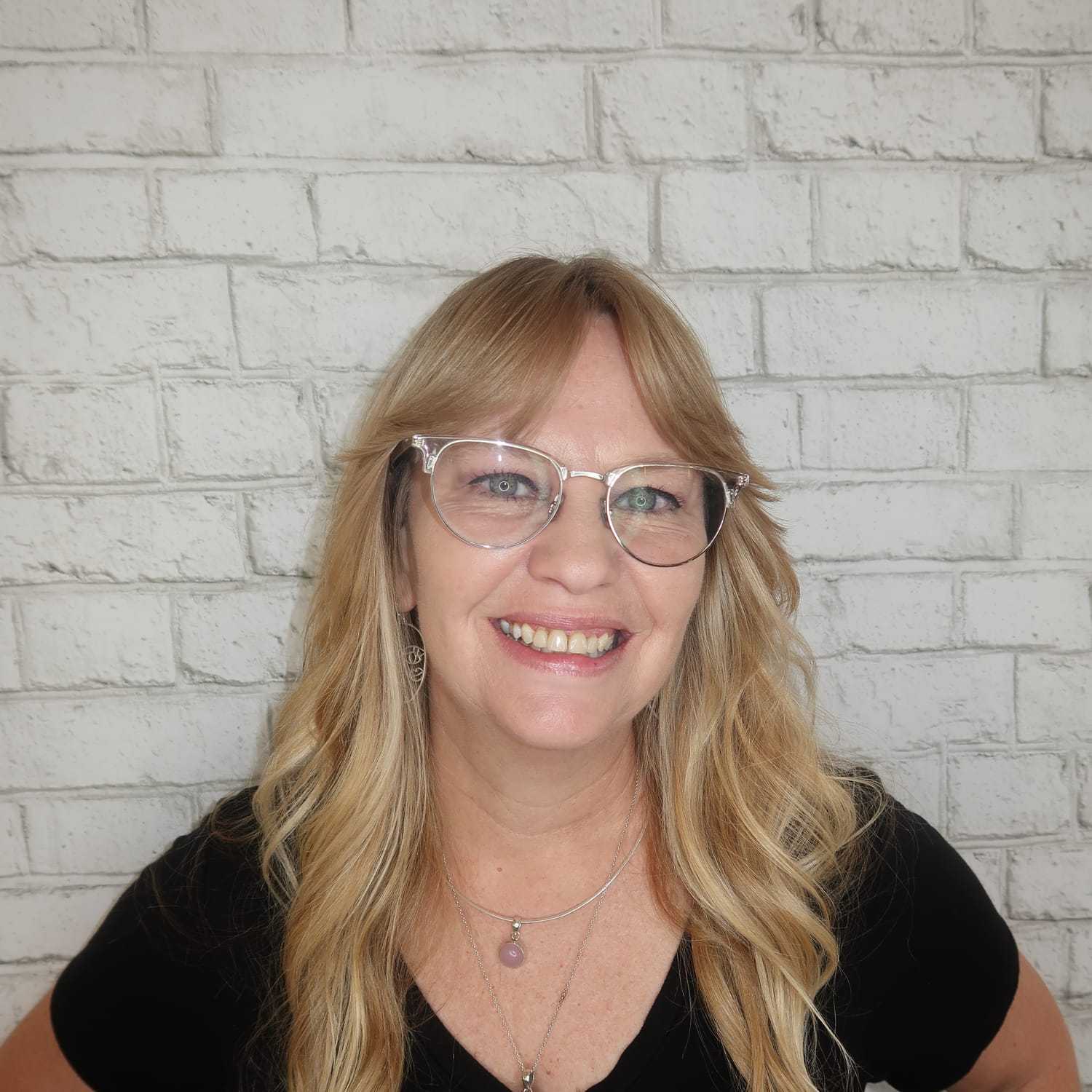 Portrait of Arlene Coates, a professional stylist at Avalon Salon for Hair and Nails, showcasing their expertise and style.