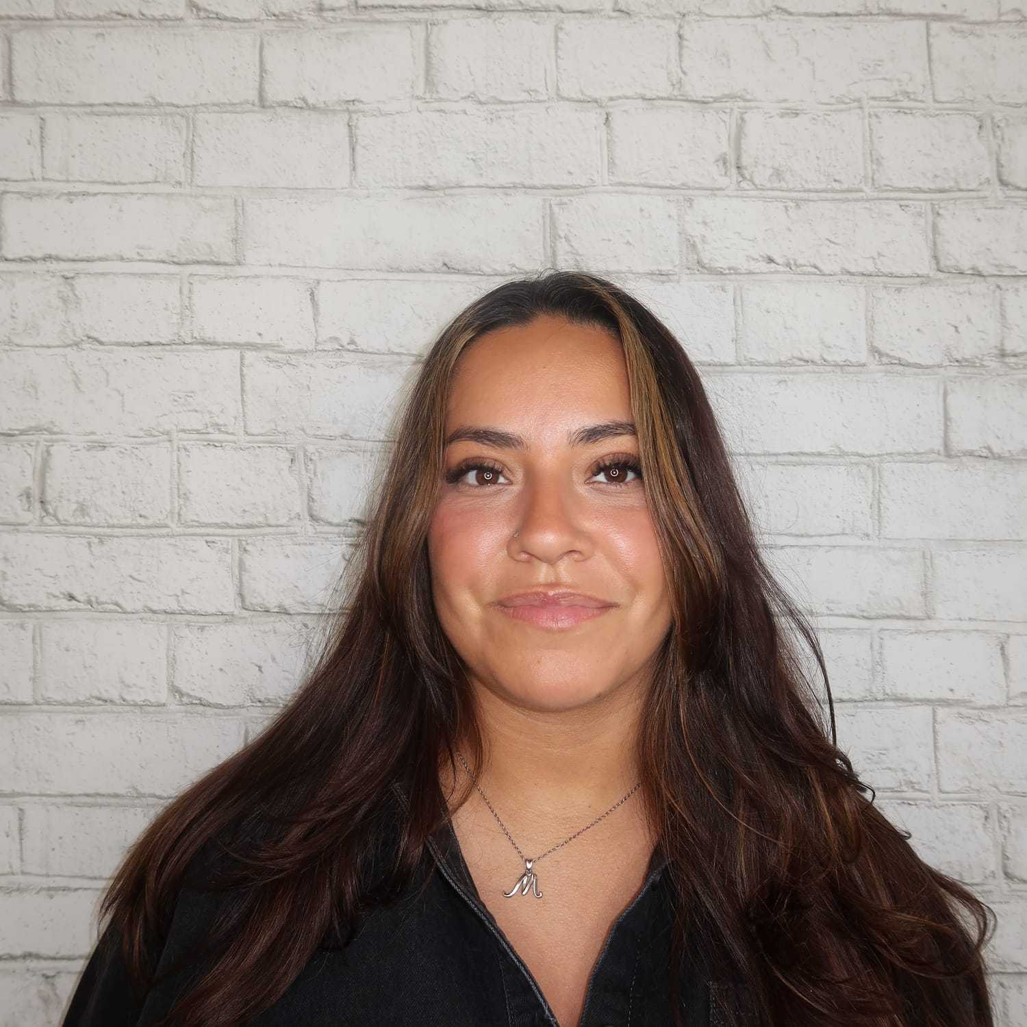 Portrait of Melanie Holguin, a professional stylist at Avalon Salon for Hair and Nails, showcasing their expertise and style.