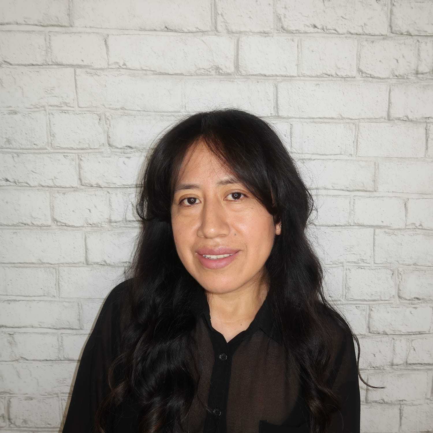 Portrait of Lily Morocho, a professional stylist at Avalon Salon for Hair and Nails, showcasing their expertise and style.