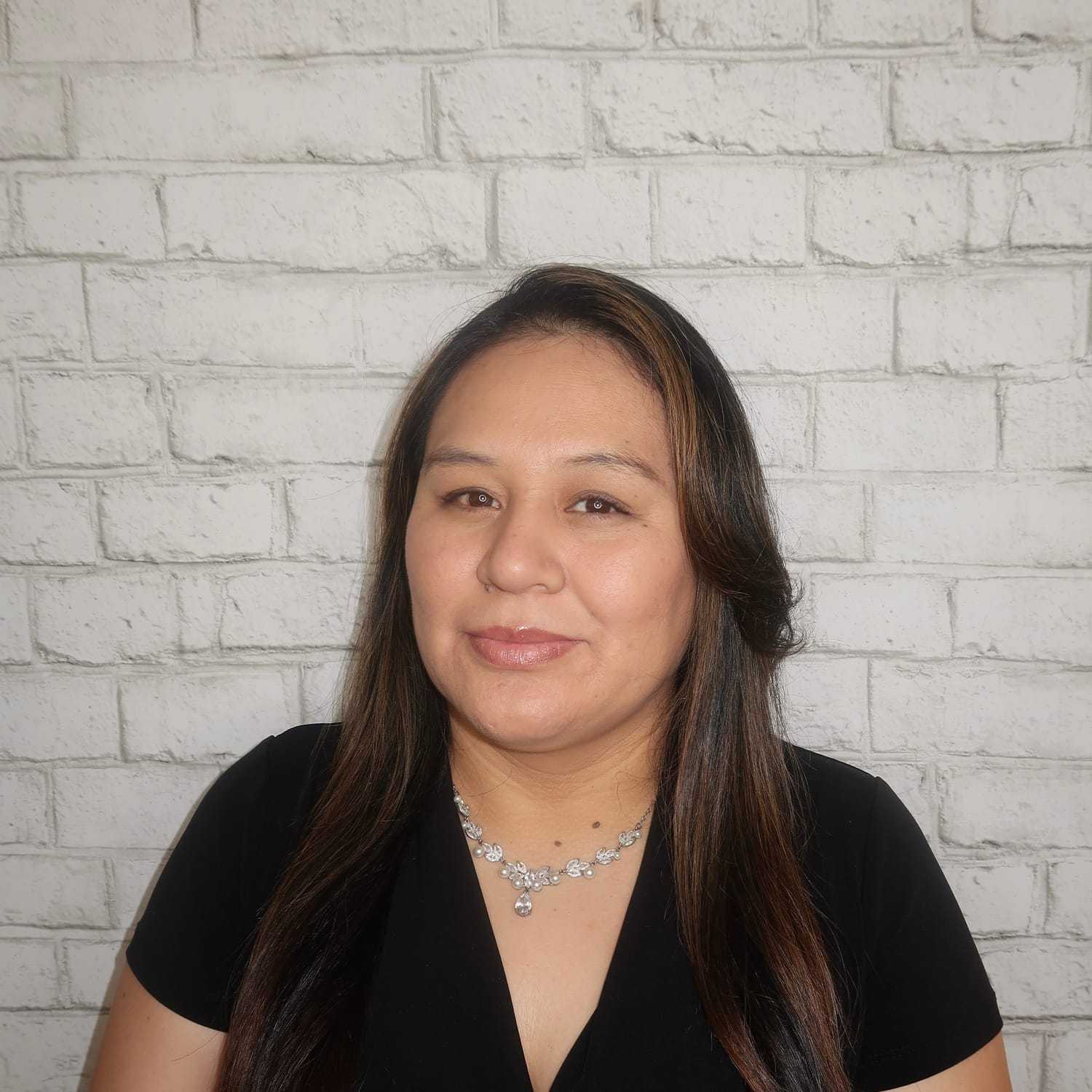 Portrait of Margarita Guallpa, a professional stylist at Avalon Salon for Hair and Nails, showcasing their expertise and style.