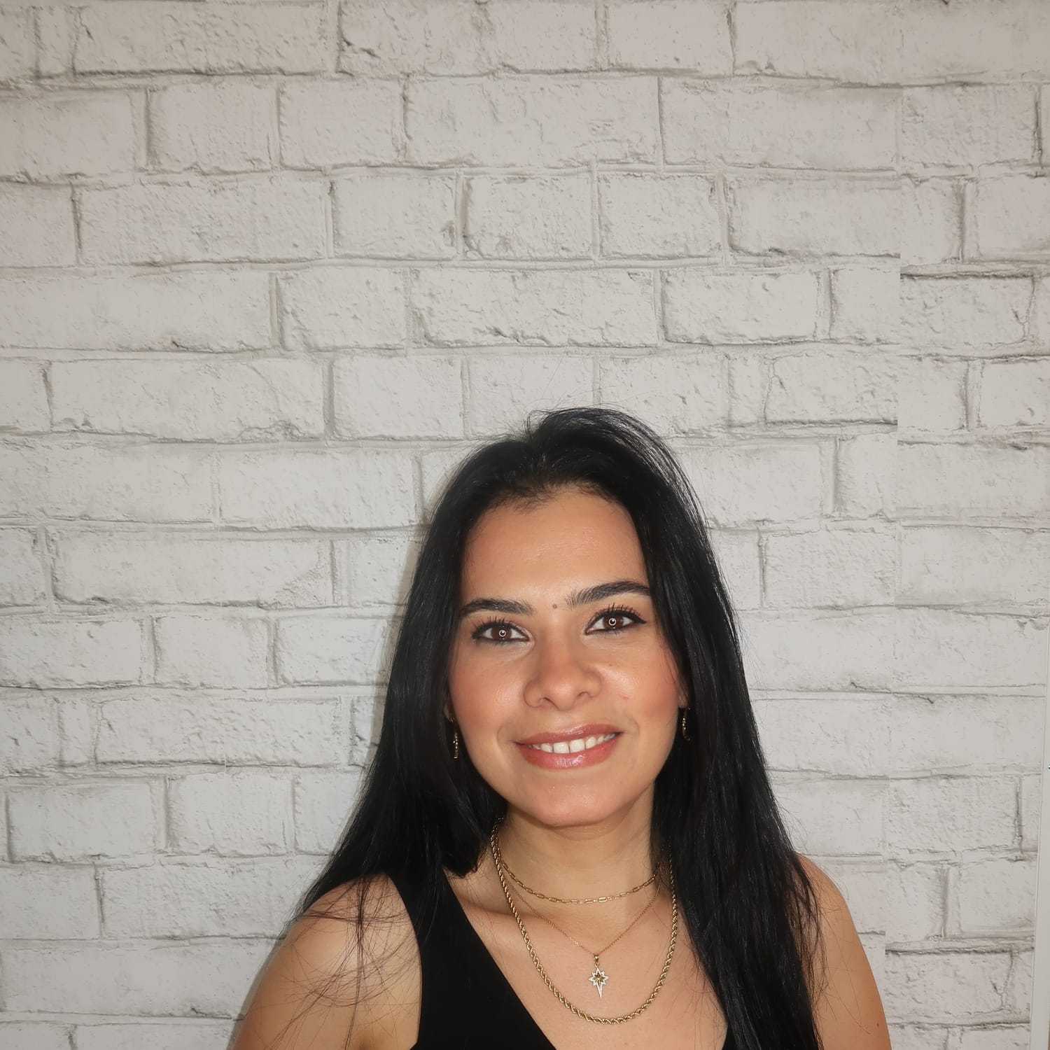 Portrait of Haidy Massoud, a professional stylist at Avalon Salon for Hair and Nails, showcasing their expertise and style.