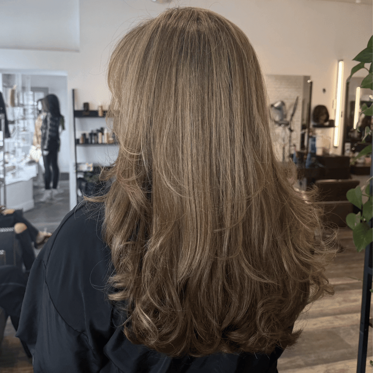 Wavy blonde hair styled in a modern salon setting.