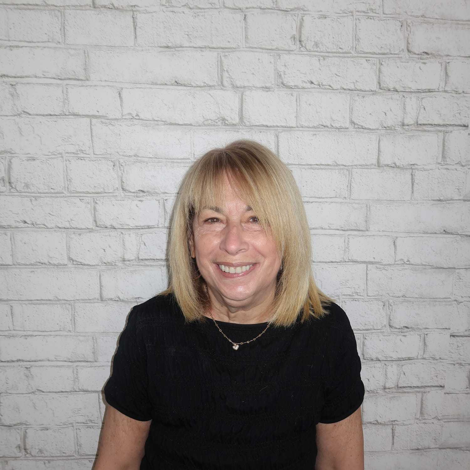 Portrait of Phyllis Taub, a professional stylist at Avalon Salon for Hair and Nails, showcasing their expertise and style.